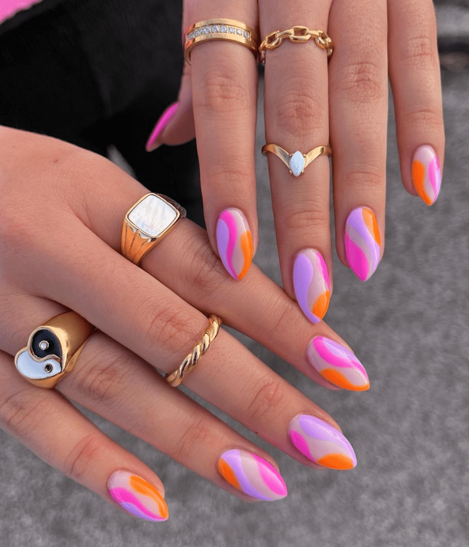 funky hot pink orange and purple bright summer nails with a curvy swirl design
