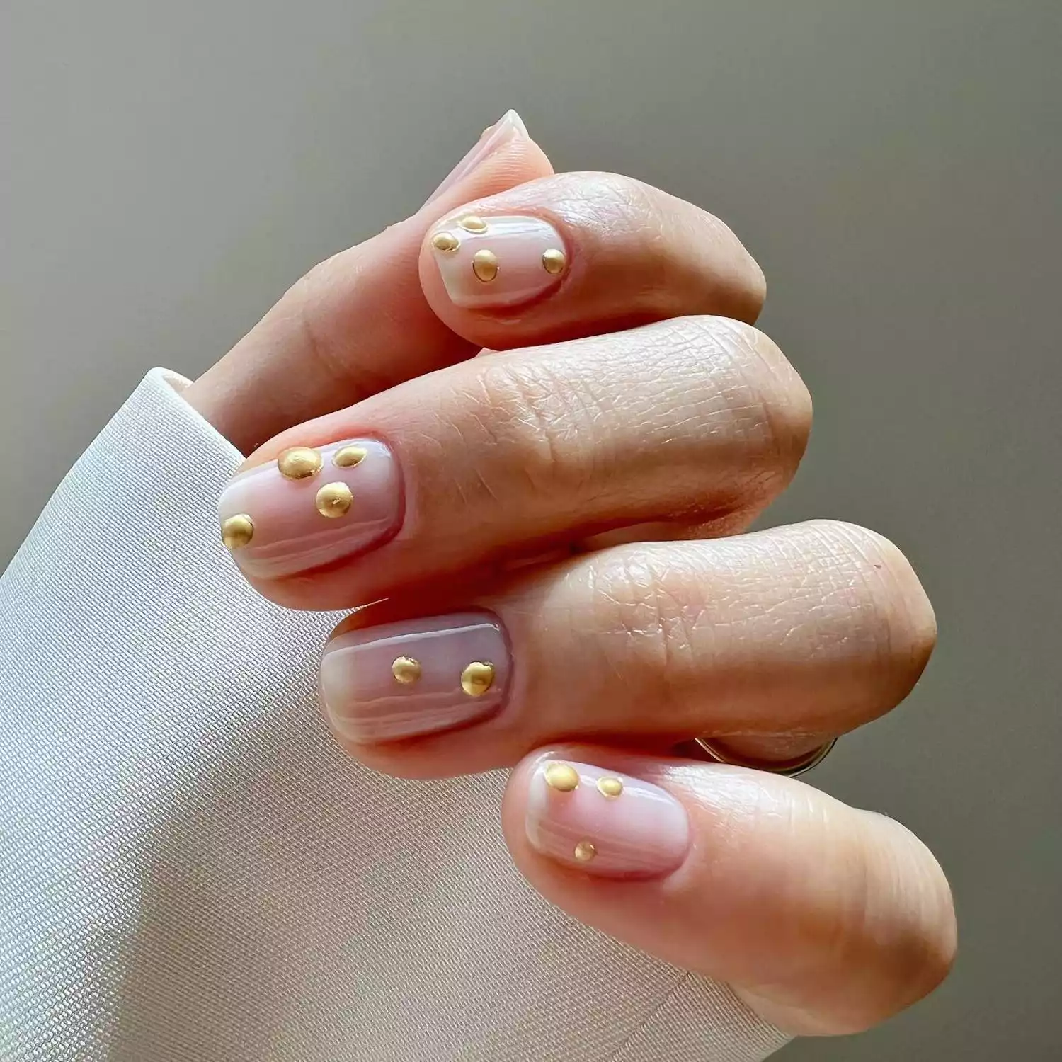 Clear manicure with 3D gold dot designs