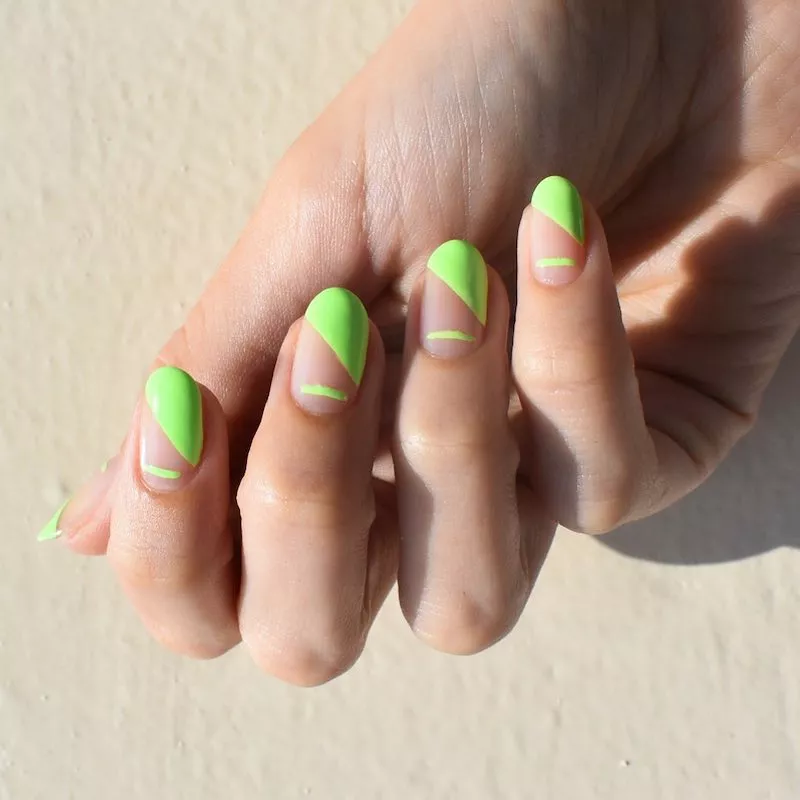 Negative space nails with lime green diagonal tip and horizontal base stripe