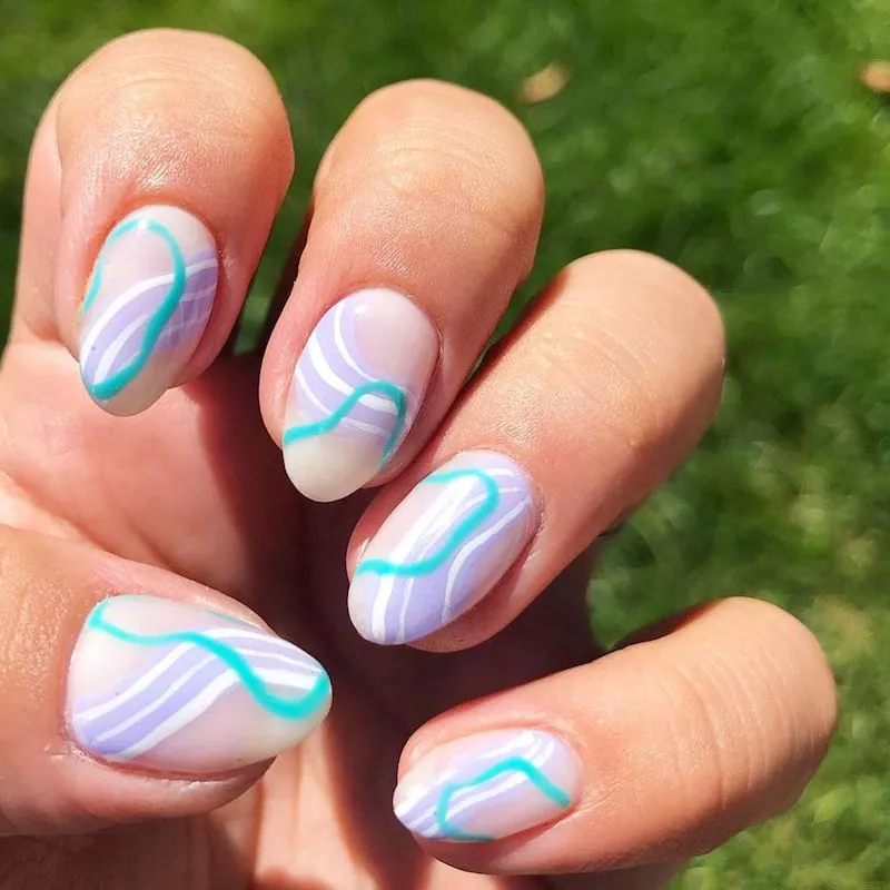 Manicure with purple, white, and blue abstract design