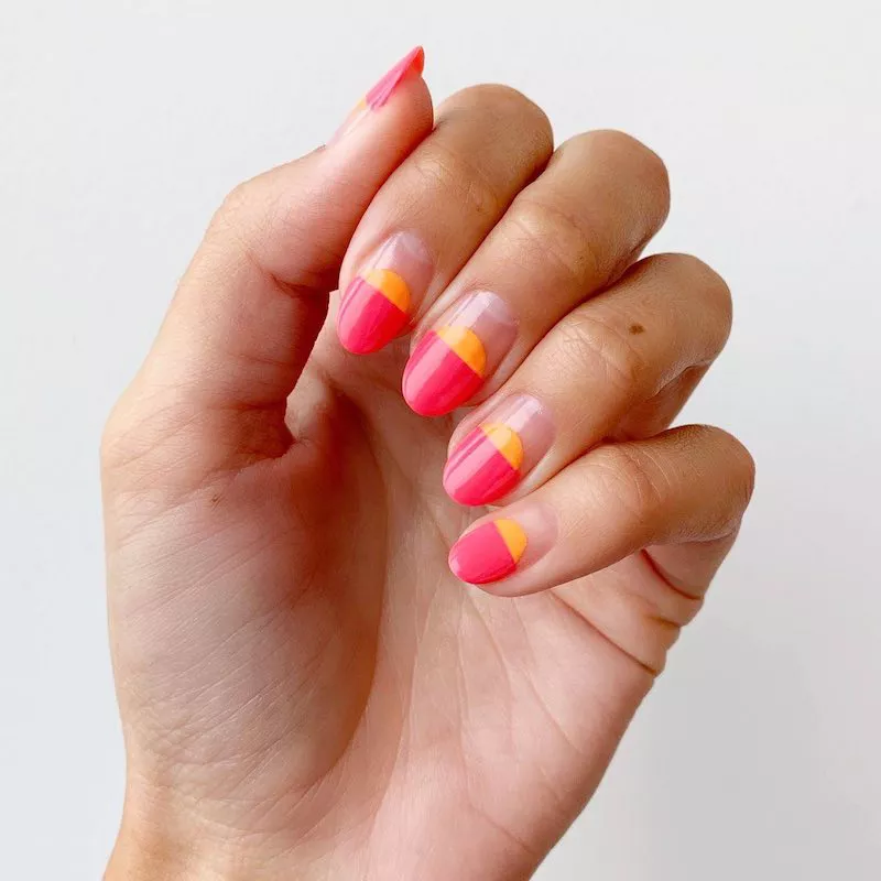 Neon pink and orange oval manicure with negative space base